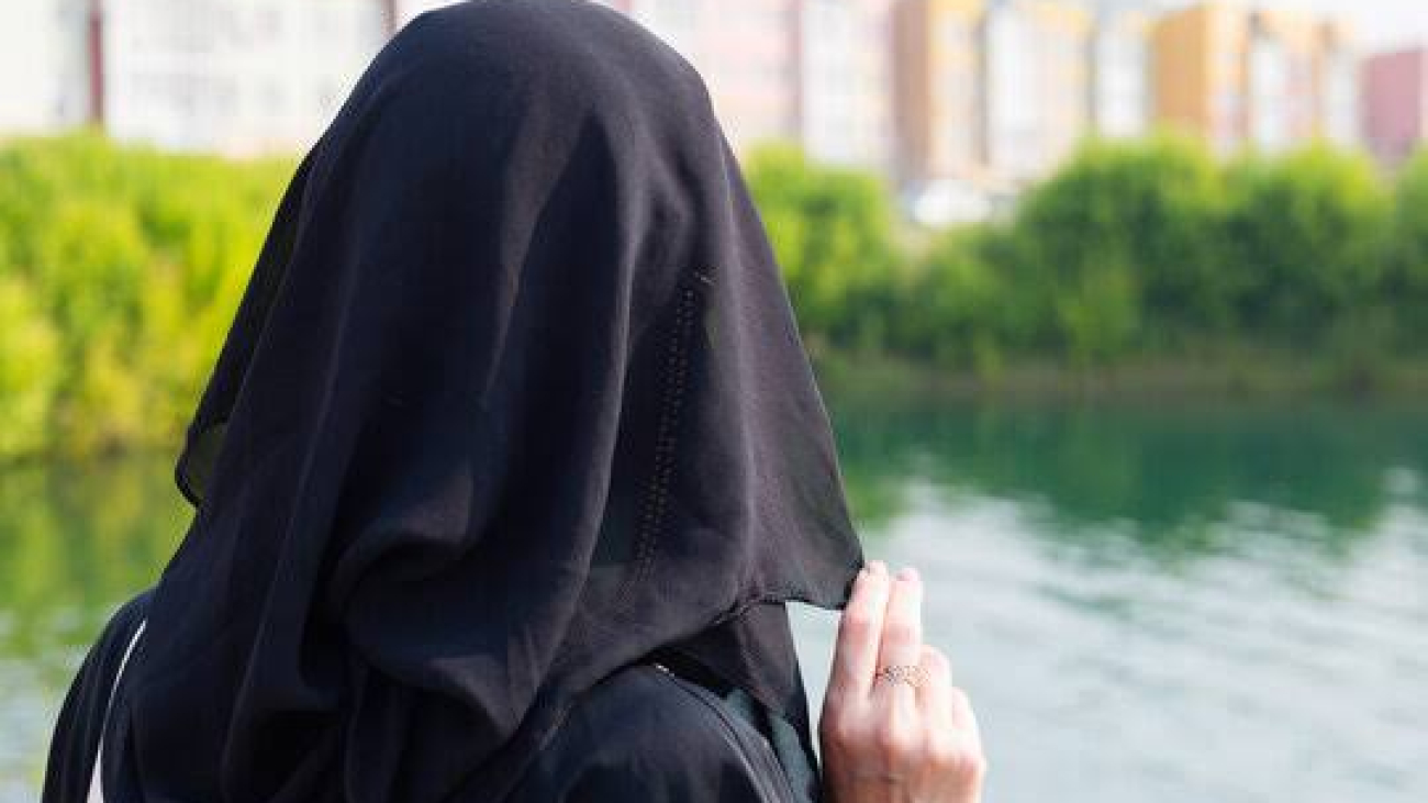 Muslim teenagers facing back